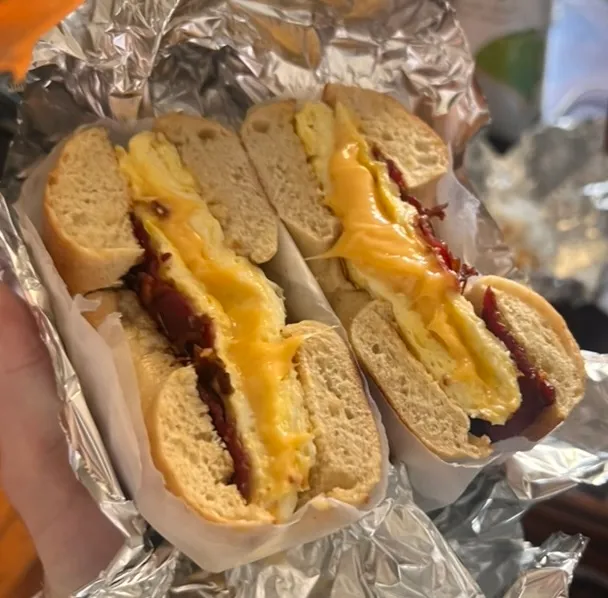 A bacon, egg and cheese bagel, unwrapped from its foil
